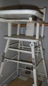 An old painted wooden high chair.