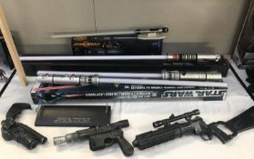 A collection of Star Wars weapons including Luke Skywalker Force fx lightsaber,