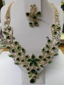 A superb green and white stone necklace with matching earrings.