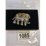 An elephant brooch set coloured stones.