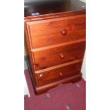 A 3 drawer stained pine bedside chest.