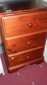 A 3 drawer stained pine bedside chest.