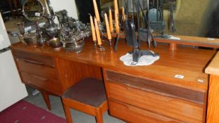 A teak dressing table with stool.