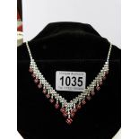 A crystal necklace with red and white stones.