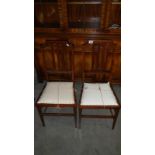 A pair of mahogany inlaid chairs.