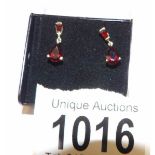 A pair of 9ct gold garnet set drop earrings.