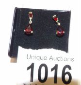 A pair of 9ct gold garnet set drop earrings.