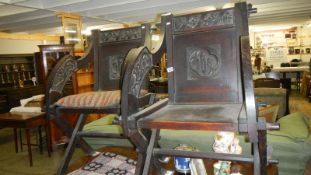 A pair of armorial chairs with monograms.
