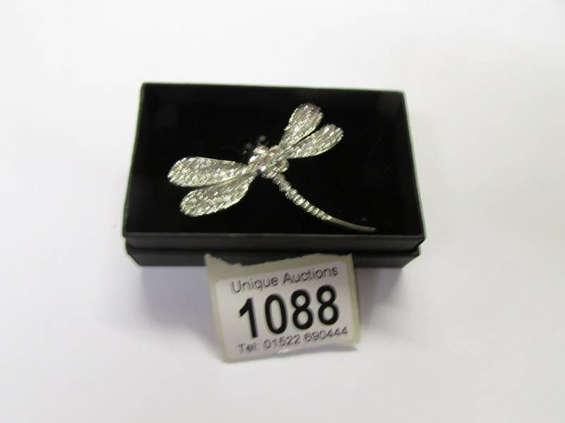 A jewelled dragon fly brooch.