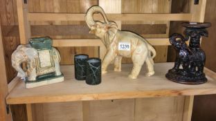 An elephant figure stand and 2 other elephant figures etc.