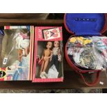Sindy dolls in boxes & a vanity case full of Sindy clothes.