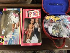 Sindy dolls in boxes & a vanity case full of Sindy clothes.