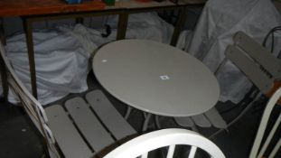 A metal garden table and 2 chairs.