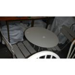 A metal garden table and 2 chairs.