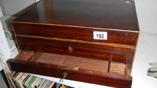 A mahogany box with drawer.