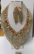 A fabulous jewelled necklace with matching earrings.