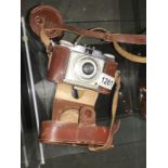 A vintage camera in leather case.