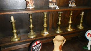 3 pairs of brass candlesticks.