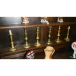 3 pairs of brass candlesticks.