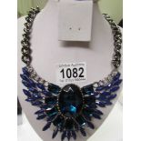 A heavy blue stone necklace.
