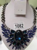 A heavy blue stone necklace.