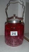 A cranberry glass biscuit barrel.