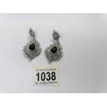 A pair of drop earrings set white stones.