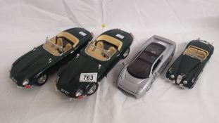 3 Burago model cars (2x Jaguar E types and a Jaguar XK120) and a Maistro model of a Jaguar XJ220.