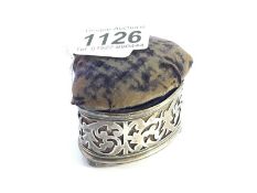 A silver trinket pot with pin cushion lid.