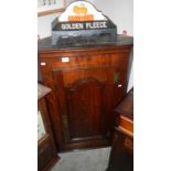 An oak corner cupboard.