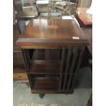 A mahogany inlaid revolving book case.