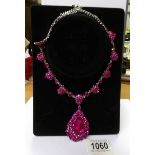 A pink jewelled necklace.