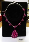 A pink jewelled necklace.