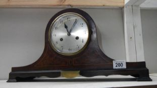 A mahogany inlaid mantel clock.