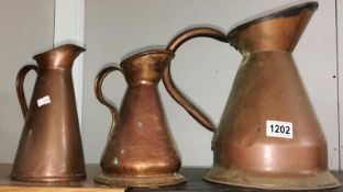 3 copper jugs.