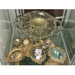 A metal dish and 7 oval metal frames.