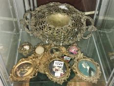 A metal dish and 7 oval metal frames.