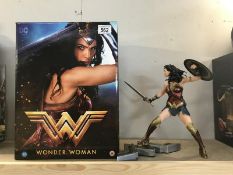 A boxed Wonder Woman statue.