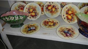 12 fruit decorated plates and 2 vases.