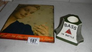 A Bass & Co. Ltd. match striker by Minton's and a 1950's Player's cigarette advertising sign.