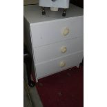 A 3 drawer white chest.