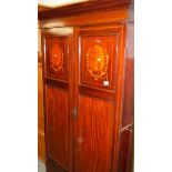 A mahogany inlaid wardrobe.