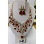 A fabulous red and white stone necklace with matching earrings.