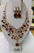 A fabulous red and white stone necklace with matching earrings.