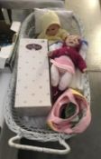 A dolls pram with 2 dolls and accessories.
