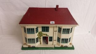 A Tri-ang spot-on dolls house and contents.