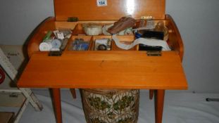 A sewing box with contents and another sewing box.