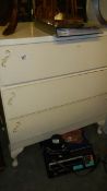 A 3 drawer white chest.