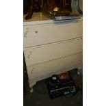 A 3 drawer white chest.