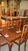A draw leaf table and 5 chairs.